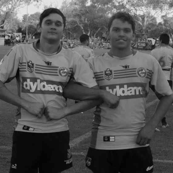 Parra Eels youth players link arms in Alice Sprigs before the Eels match against Gold Coast Titans.