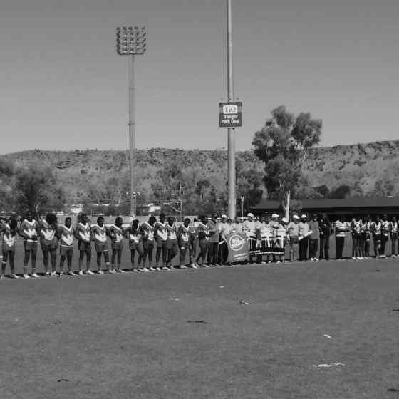 AFLCA Division 1 Grand Final teams Ti Tree Roosters and Yuendumu Magpies link up to say NO MORE to family violence at Traeger Park in Alice Springs.