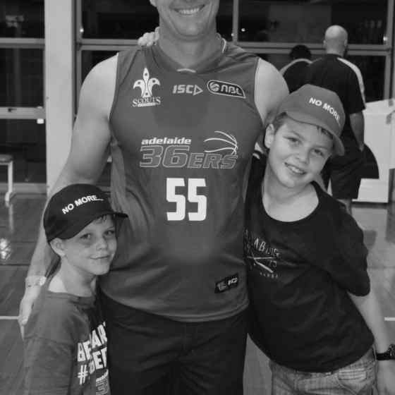 Michael Moriaty with his sons supporting the Adelaide 36ers and NO MORE to family violence.