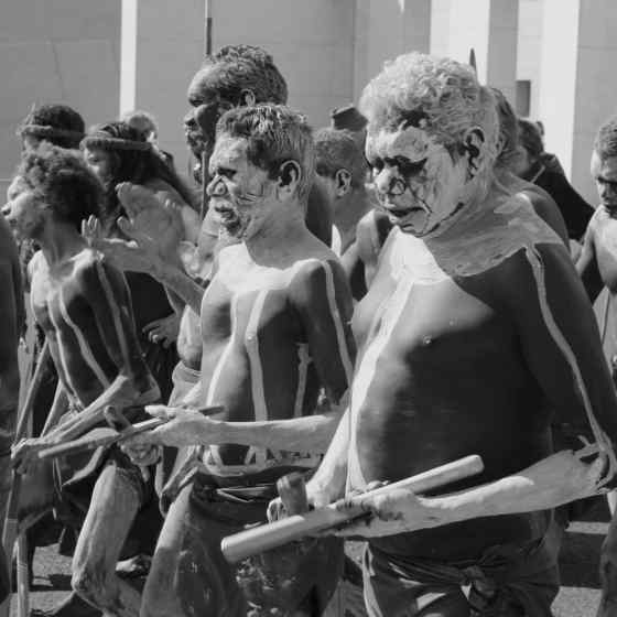 Rirratjingu dancers walking out in front of Parliament House.