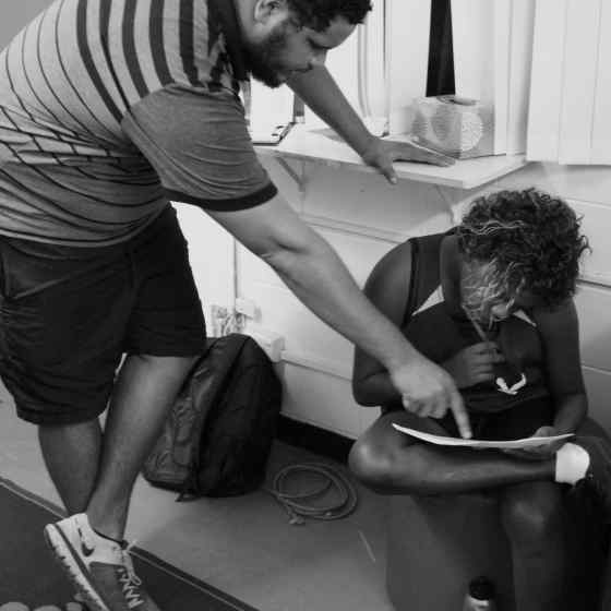 Every week, teams attended workshops in between playing basketball games. The workshop topics varied over the 8 week program. Topics included drug and alcohol use, healthy behaviours and rock throwing to name a few. Youth worker, Jonathon McDonald, helps one of the players with their evaluation. 