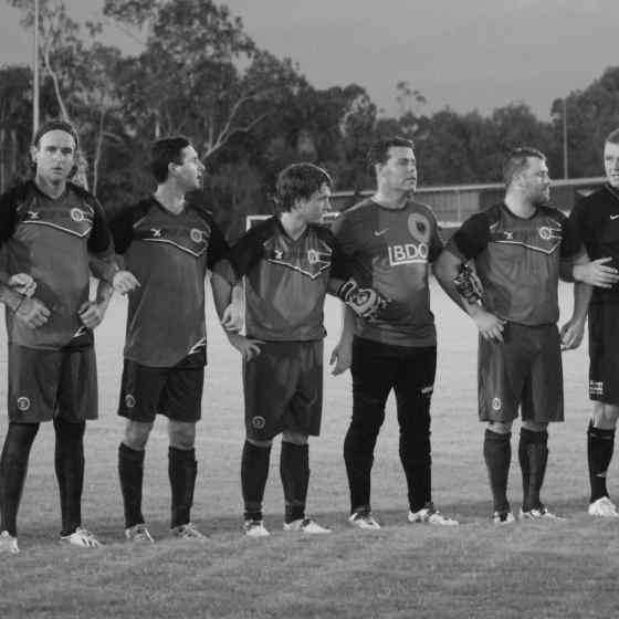 Palmerston Football Club link arms before the match. 