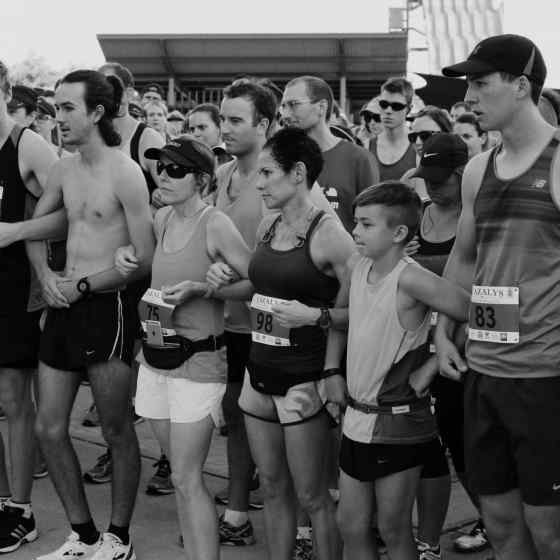 Race goers all link arms in support of the NO MORE family violence message.