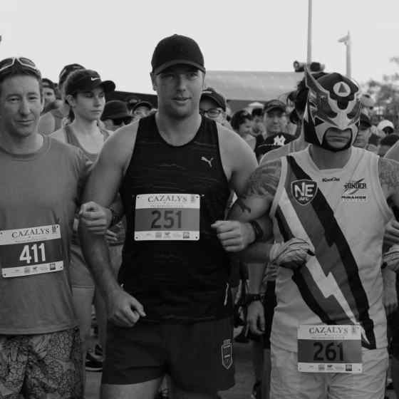 Race goers all link arms in support of the NO MORE family violence message.