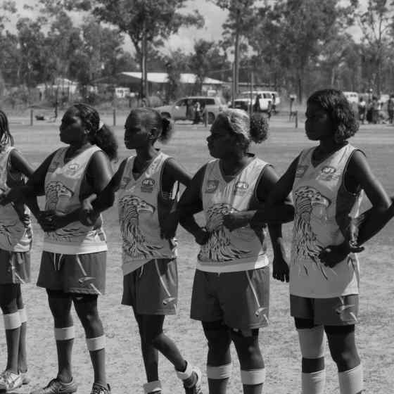 Damala Eagles link arms before the women's grand final match.