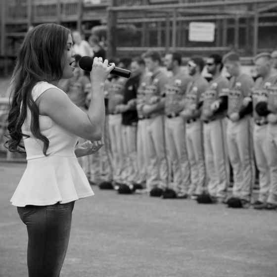 Eclipse Dance & Performing Arts singing our National Anthem, Advanced Australia Fair, as players link arms showing that Canberra Cavalry take a public stand against family & domestic violence. Photo Credit: Wendy De'Souza