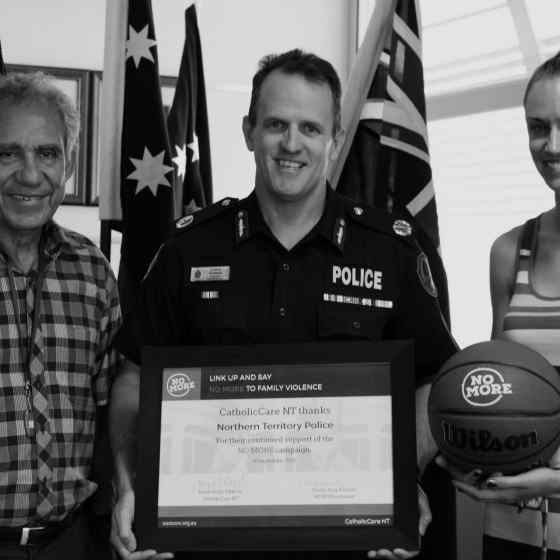 NO MORE campaign founder Charlie King and campaign project worker Alex Billeter present an award to NT Police Assistant Commissioner Lance Godwin for their continued support and recognition of the work the NT Police have been doing to end family and domestic violence. 