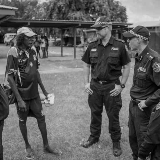 NT Police chat with the local footy chairman. Photo Credit: NT Police