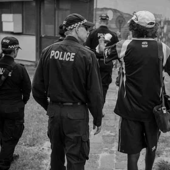 NT Police chat with the local footy chairman. Photo Credit: NT Police